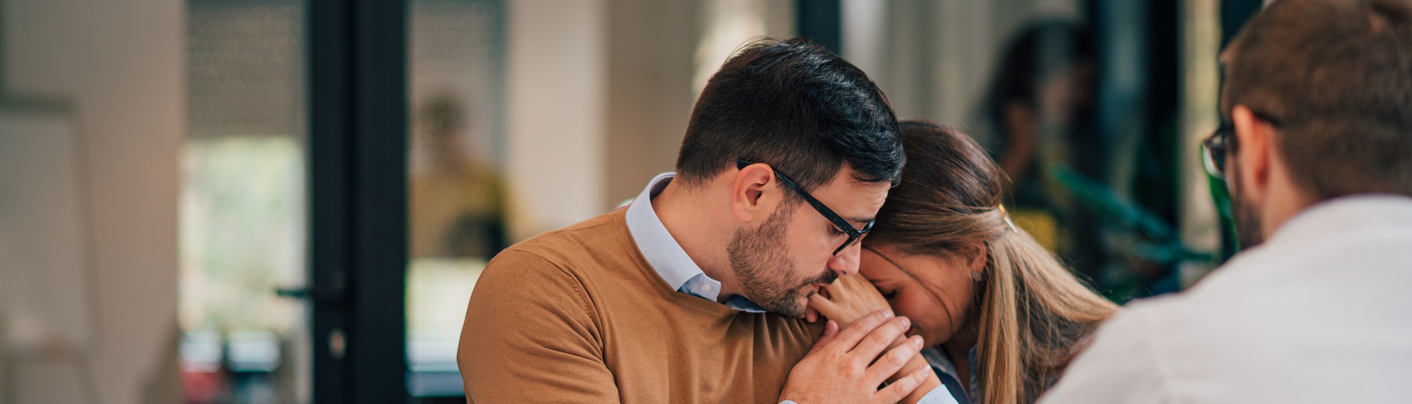 Bad News Concept. Man Comforting His Wife While Sitting Together With Doctor Of Financial Adviser.