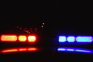police lights pulling a car over for drugged driving
