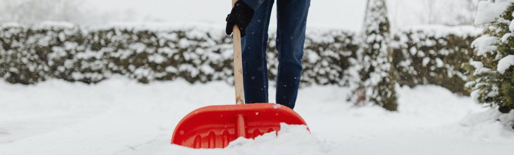 phot of person shoveling their property after a snowstorm