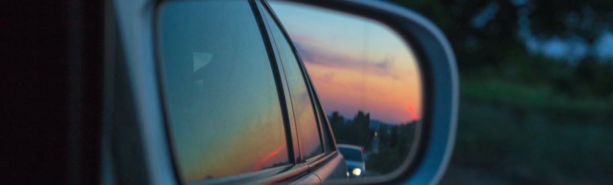 photo of side view mirror with sunset in background