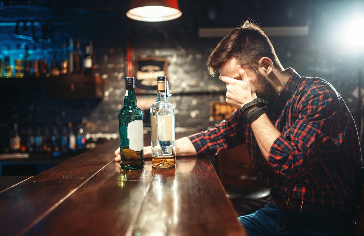 Alcoholic Sitting At Bar And Drinks Strong Alcohol