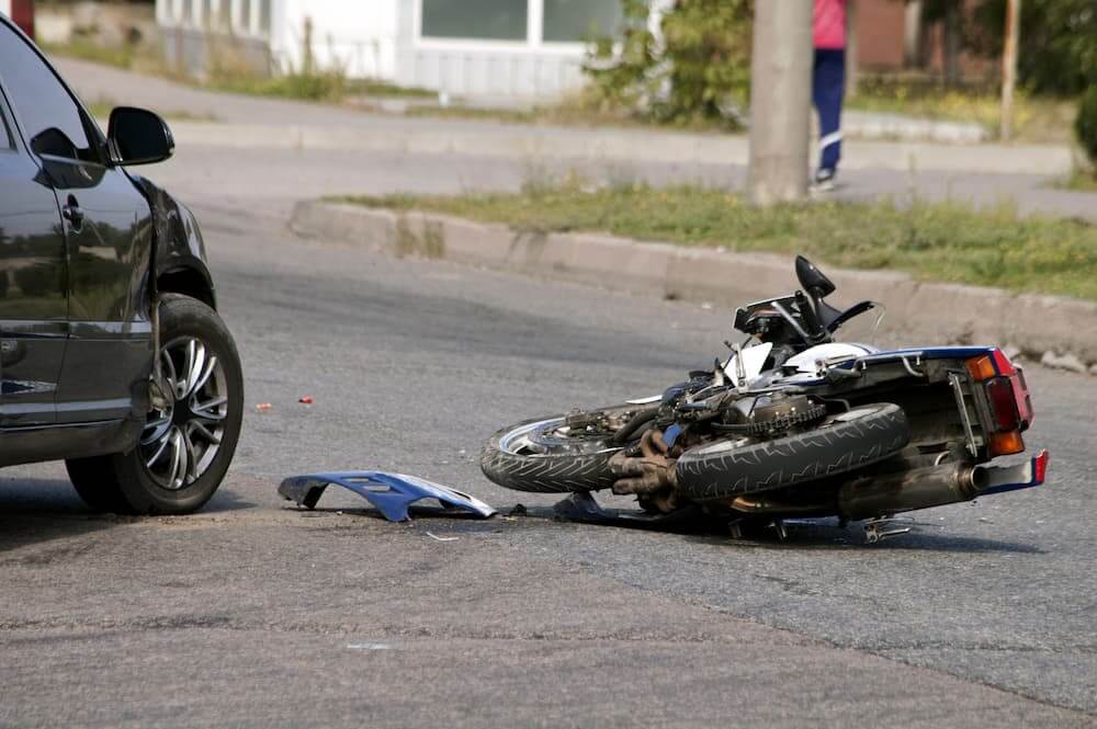 image of wrecked motorcycle to show common motorcycle accident injuries for Flager Law